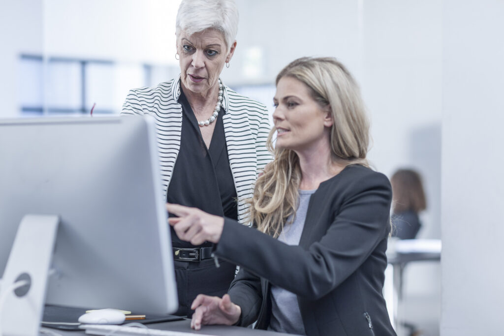 A senior manager coaching a junior executive